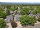 An aerial view of the neighborhood showcasing the home's location amongst lush greenery and mountain views at 9665 Whitecliff Pl, Highlands Ranch, CO 80129