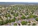 Wide aerial view of the neighborhood with the home highlighted via a red arrow, in a lush community at 9665 Whitecliff Pl, Highlands Ranch, CO 80129