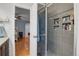 Renovated bathroom with glass-enclosed shower with custom tiling and built in shelving at 9665 Whitecliff Pl, Highlands Ranch, CO 80129