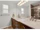 Bathroom featuring a double sink vanity with marble countertops, modern fixtures, and a tiled shower at 9665 Whitecliff Pl, Highlands Ranch, CO 80129