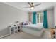 Cozy bedroom featuring plush carpet, ceiling fan, and a window with bright turquoise curtains at 9665 Whitecliff Pl, Highlands Ranch, CO 80129