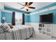 Bedroom featuring a ceiling fan, a large window, and white wainscoting along the lower walls at 9665 Whitecliff Pl, Highlands Ranch, CO 80129