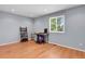 Bright bedroom featuring hardwood floors, a window with natural light, and a flexible workspace at 9665 Whitecliff Pl, Highlands Ranch, CO 80129