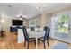 Dining area with hardwood floors, chandelier, and sliding glass doors to the backyard at 9665 Whitecliff Pl, Highlands Ranch, CO 80129