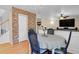 Dining area with brick accent wall, chandelier, and hardwood floors at 9665 Whitecliff Pl, Highlands Ranch, CO 80129