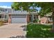 Charming two-story home featuring a two-car garage, a brick facade, and a well-maintained front yard at 9665 Whitecliff Pl, Highlands Ranch, CO 80129