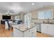 Bright kitchen with white cabinets, granite countertops, and stainless steel appliances at 9665 Whitecliff Pl, Highlands Ranch, CO 80129