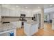 Bright kitchen featuring stainless steel appliances, a center island, and hardwood floors at 9665 Whitecliff Pl, Highlands Ranch, CO 80129