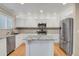 Well-lit kitchen with stainless steel appliances, granite countertops, and ample cabinet space at 9665 Whitecliff Pl, Highlands Ranch, CO 80129