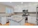 Modern kitchen with stainless steel appliances, granite countertops, and white cabinetry at 9665 Whitecliff Pl, Highlands Ranch, CO 80129