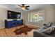 Living room featuring hardwood floors, ceiling fan, and large window at 9665 Whitecliff Pl, Highlands Ranch, CO 80129