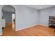 Open living room with hardwood floors and an arched doorway leading to an adjacent room at 9665 Whitecliff Pl, Highlands Ranch, CO 80129