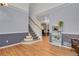 Spacious living room with hardwood floors, staircase and open access to dining area at 9665 Whitecliff Pl, Highlands Ranch, CO 80129