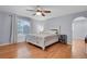 Spacious main bedroom with hardwood floors, ceiling fan, and large window at 9665 Whitecliff Pl, Highlands Ranch, CO 80129