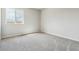 Simple bedroom with grey carpet and a window offering a view at 42734 Calusa Pines Rd, Elizabeth, CO 80107