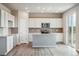 Modern kitchen with white cabinets, island, and patio access at 42734 Calusa Pines Rd, Elizabeth, CO 80107