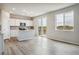 Modern kitchen with white cabinets, island, and large windows at 42734 Calusa Pines Rd, Elizabeth, CO 80107