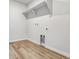 Bright laundry room with wood-look flooring and ample shelving at 42734 Calusa Pines Rd, Elizabeth, CO 80107