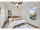 Cozy bedroom filled with natural light features a unique headboard and ceiling fan at 194 S Emerson St, Denver, CO 80209
