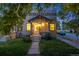 Charming stone-clad home with a well-maintained lawn and inviting covered front porch entrance at 194 S Emerson St, Denver, CO 80209