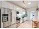 Clean kitchen offers stainless steel appliances, white cabinetry, tile floors, and ample natural light at 194 S Emerson St, Denver, CO 80209