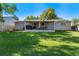 Spacious backyard featuring a well-maintained lawn, covered patio and mature trees offering shade at 10640 Nw Routt Way, Westminster, CO 80021