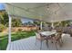 Covered patio with backyard featuring a patio table with chairs and a green lawn at 10640 Nw Routt Way, Westminster, CO 80021