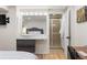 Basement bathroom and bedroom featuring a modern vanity and a tiled shower with glass door at 10640 Nw Routt Way, Westminster, CO 80021