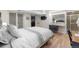 Basement bedroom featuring a stylish bed, hardwood floors, vanity, and ensuite bathroom at 10640 Nw Routt Way, Westminster, CO 80021