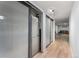 Basement hallway with hardwood floors leading to storage and play area at 10640 Nw Routt Way, Westminster, CO 80021