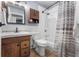 Bathroom with wood vanity, mirror, tiled shower, and bathtub at 10640 Nw Routt Way, Westminster, CO 80021