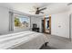 Bright bedroom with large window, ceiling fan, and view of mirrored barn door to walk in closet at 10640 Nw Routt Way, Westminster, CO 80021
