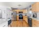 Well-equipped kitchen with stainless appliances, wood cabinets, and plenty of countertop space for meal preparation at 10640 Nw Routt Way, Westminster, CO 80021