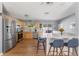Bright kitchen with stainless steel appliances, light wood cabinets, quartz countertops, and breakfast bar seating at 10640 Nw Routt Way, Westminster, CO 80021