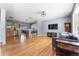 Open-concept living space with hardwood floors combining kitchen, dining, and living room areas for modern living at 10640 Nw Routt Way, Westminster, CO 80021