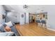 Open-concept living space with kitchen, dining, and living areas featuring hardwood floors and stylish furnishings at 10640 Nw Routt Way, Westminster, CO 80021