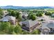 Panoramic aerial view of a tranquil neighborhood with lush landscaping, mature trees, and stunning mountain views at 20401 High Pines Dr, Monument, CO 80132