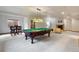Finished basement featuring a pool table, wet bar, and stone fireplace at 20401 High Pines Dr, Monument, CO 80132