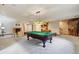 Spacious basement featuring a pool table, fireplace, and wet bar area for entertaining guests at 20401 High Pines Dr, Monument, CO 80132