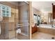 Modern bathroom featuring a glass shower, tub, and dual sink vanity for a luxurious feel at 20401 High Pines Dr, Monument, CO 80132