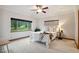 Bright bedroom with a ceiling fan and a large window offering natural light and outdoor views at 20401 High Pines Dr, Monument, CO 80132