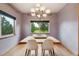 Bright dining room with natural light, hardwood floors, a modern chandelier, and views of the outdoors at 20401 High Pines Dr, Monument, CO 80132