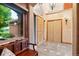 Inviting foyer with decorative bench, tiled floor, and natural light from the large window at 20401 High Pines Dr, Monument, CO 80132