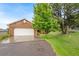 Home exterior with a two-car garage and well-manicured lawn and mature trees creating curb appeal at 20401 High Pines Dr, Monument, CO 80132