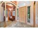 Inviting foyer with tile flooring, a wooden front door, and a comfortable seating area at 20401 High Pines Dr, Monument, CO 80132