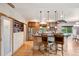 Bright kitchen featuring a breakfast bar, stainless steel appliances, hardwood floors, and built-in shelving at 20401 High Pines Dr, Monument, CO 80132