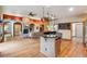 Spacious kitchen featuring stainless steel appliances, hardwood floors, and open access to the living and dining areas at 20401 High Pines Dr, Monument, CO 80132