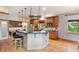 Kitchen with breakfast bar, stainless steel appliances, hardwood floors, granite countertops, and built-in shelving at 20401 High Pines Dr, Monument, CO 80132