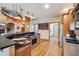 Open-concept kitchen featuring stainless steel appliances, hardwood floors, granite countertops and built-in shelving at 20401 High Pines Dr, Monument, CO 80132