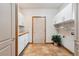 Functional laundry room with ample storage cabinets and a tiled floor and plant at 20401 High Pines Dr, Monument, CO 80132